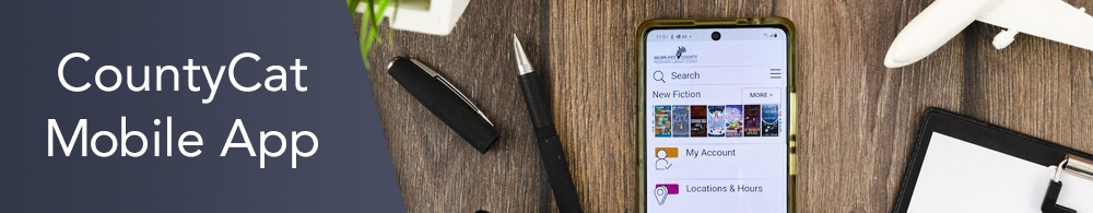 Phone laying on a desk featuring the CountyCat Mobile app