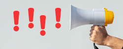 Megaphone blowing out exclamation points